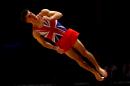 Britain's Max Whitlock performs during his floor routine as he takes part in the men's qualification competition at the World Artistic Gymnastics championships in Glasgow, Scotland, Sunday, Oct. 25, 2015. (AP Photo/Matthias Schrader)