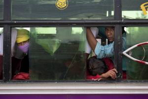 Nepalese people look out from inside a bus where they &hellip;