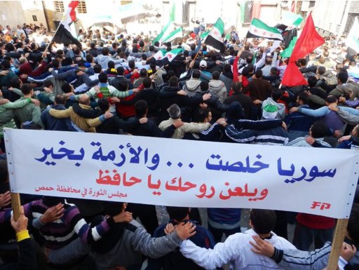 Demonstrators protesting against Syria's President Bashar al-Assad march in Homs