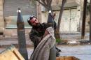 A Syrian pro-government fighter polishes a shell in the town of Nabak near Damascus on December 7, 2013