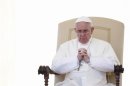 Pope Francis prays as he leads the weekly audience in Saint Peter's Square at the Vatican