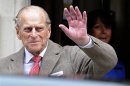 Britain's Prince Philip waves to members of the media as he leaves the King Edward VII Hospital in London