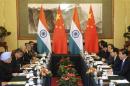 China's President Xi talks with India's PM Singh during a meeting in Beijing