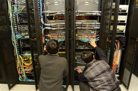 Employees of the Korean Broadcasting System (KBS) inspect a server to recover it at the company's main office in Seoul March 21, 2013 in this picture taken by KBS. REUTERS/KBS/Handout