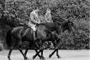FILE - In this June 8, 1982 file photo, U.S. President Ronald Reagan, on Centennial, and Britain's Queen Elizabeth II, on Burmese, go horseback riding on the grounds of Windsor Castle, England. It is not often that the president of the United States needs to seek fashion advice. But when Ronald Reagan was getting ready for a visit to England as a guest of Queen Elizabeth II in June 1982, his people had an important question for the Brits: Just what does one wear to go riding with the queen in the magnificent horse country surrounding Windsor Castle? The answer: Something smart, but casual, of course. Riding boots, breeches and a turtleneck sweater would do fine _ no need for formal riding attire. The fashion inquiry is but one tidbit contained in nearly 500 pages of formerly Confidential documents relating to the Reagan visit being made public Friday, Dec. 28, 2012 by Britainâ€™s National Archives. (AP Photo/Bob Daugherty, File)