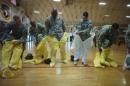 U.S. Army soldiers from the 101st Airborne Division (Air Assault), who are earmarked for the fight against Ebola, put on protective suits during training before their deployment to West Africa, at Fort Campbell