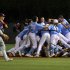 North Carolina celebrates their 12-11 win over Florida Atlantic in 13 innings during an NCAA college regional championship baseball game in Chapel Hill, N.C., Monday, June 3, 2013, as Florida Atlantic's Brendon Sanger, left, walks off the field.  (AP Photo/Ted Richardson)