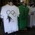 In this photo taken Monday, July 16, 2012, a t-shirt depicting a rioter holding an Olympic ring is displayed on sale in a London market. The guardians of the games are vigilant about protecting the integrity - and the commercial clout - of the Olympic brand. But even they can't stop the irreverent spirit of artists and craftspeople, who have responded to the games with a cheeky mix of celebration, skepticism and satire. (AP Photo/Matt Dunham)