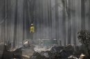 A firefighter stands on top of a fire truck at a campground destroyed by the Rim Fire near Yosemite National Park, Calif., on Monday, Aug. 26, 2013. Crews working to contain one of California's largest-ever wildfires gained some ground Monday against the flames threatening San Francisco's water supply, several towns near Yosemite National Park and historic giant sequoias. (AP Photo/Jae C. Hong)