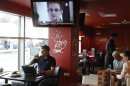A television screen shows former U.S. spy agency contractor Snowden during a news bulletin at a cafe at Moscow's Sheremetyevo airport