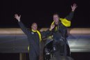 Pilots and founders Piccard and Borschberg wave to crowd after Solar Impulse lands at JFK airport in New York