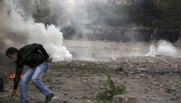Protesters and riot police clash near Tahrir Square in Cairo