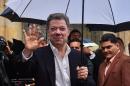 Colombian President Juan Manuel Santos waves after casting his vote during a referendum on whether to ratify a historic peace accord to end a 52-year war between the state and the communist FARC rebels, in Bogota on October 2, 2016