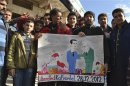 Demonstrators hold a placard during a protest against Syria's President Bashar al-Assad, after Friday prayers in Kafranbel near Idlib