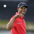 Tiger Woods looks back to catch a ball after his caddie cleaned it on the eighth green during the final round of the Cadillac Championship golf tournament on Sunday, March 10, 2013, in Doral, Fla. Woods won the championship. (AP Photo/Wilfredo Lee)