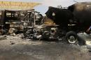 The wreckage of a truck and an aircraft are seen at Tripoli airport on July 14, 2014