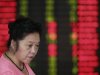 An investor looks at the stock price monitor at a private securities company in Shanghai, China, Tuesday Sept. 25, 2012. Asian stock markets were held in check Tuesday by a host of concerns about the global economy. (AP Photo/Eugene Hoshiko)
