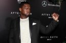 Rapper Curtis "50 Cent" Jackson jokingly makes a fist as he arrives for the premiere of the film "After Earth" in New York