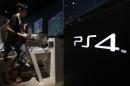 File picture of a man plays a video game on Sony Corp's Play Station 4 console at its showroom in Tokyo