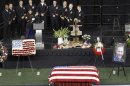 Taya Kyle is steadied by Marine while addressing friends and family during memorial service for slain husband and former Navy SEAL sniper Chris Kyle at Cowboys Stadium in Arlington