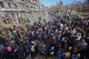 Syrian residents fleeing the violence gather at a checkpoint, manned by pro-government forces, in the Maysaloun neighbourhood of the northern embattled Syrian city of Aleppo on December 8, 2016