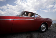 Irv Gordon poses for a picture in his Volvo P1800 in Babylon, N.Y., Monday, July 2, 2012. Gordon's car already holds the world record for the highest recorded milage on a car and he is less than 40,000 miles away from passing three million miles on the Volvo. (AP Photo/Seth Wenig)