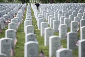 A man pauses at a grave during Memorial Day celebrations at Arlington National Cemetery