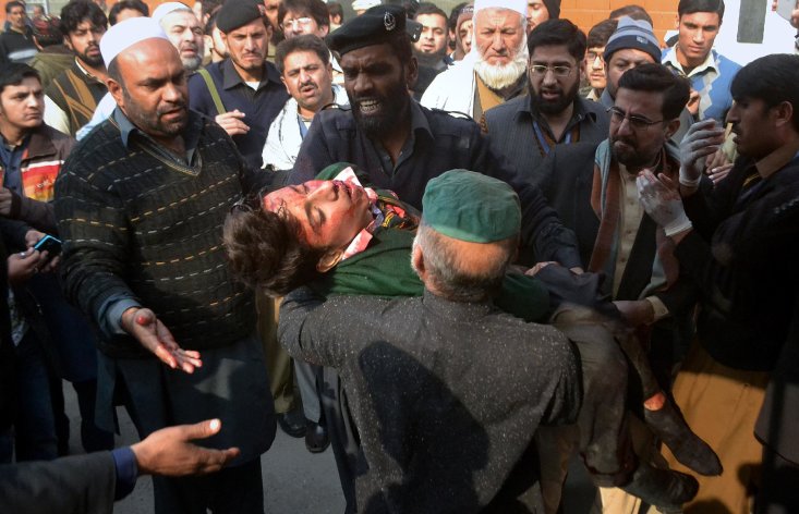 CLICK IMAGE for slideshow: Hospital security guards carry a students injured in the shootout at a school under attacked by Taliban gunmen in Peshawar, Pakistan,Tuesday, Dec. 16, 2014. Taliban gunmen stormed a military school in the northwestern Pakistani city, killing and wounding dozens, officials said, in the latest militant violence to hit the already troubled region. (AP Photo/Mohammad Sajjad)(AP Photo/Mohammad Sajjad)