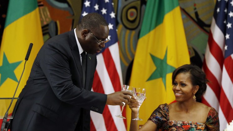 Senegal's President Macky Sall toasts alongside U.S first lady Michelle Obama during an official dinner with U.S. President Obama at the Presidential Palace in Dakar