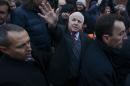 U.S. Senator McCain waves during a visit to a pro-European integration mass rally at Independence Square in Kiev