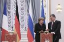 Ukraine's President Petro Poroshenko talks to Germany's Chancellor Angela Merkel as they take part in peace talks on resolving the Ukrainian crisis in Minsk