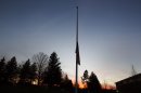 A U.S. flag flies at half staff in front of the Reed Intermediate School in Newtown, Connecticut, following a shooting nearby at Sandy Hook Elementary School