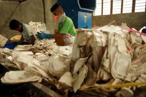 Employees place used styrofoam into a shredder at a&nbsp;&hellip;