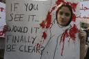 An activist holds a banner during a march against domestic violence against women, marking International Women's Day in Beirut