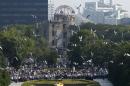 Doves fly over the Peace Memorial Park with the Atomic Bomb Dome in the background, at a ceremony in Hiroshima