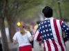 Conn Jackson, of Atlanta, right, wears a shirt decorated with the flag of the United States as he takes part in an organized moment of silence and memorial run to show solidarity with victims of the Boston Marathon bombing, Tuesday, April 16, 2013, in Atlanta. The explosions Monday afternoon killed at least three people and injured more than 140. (AP Photo/David Goldman)
