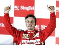 Ferrari Formula One driver Fernando Alonso of Spain gestures on the podium after the Singapore F1 Grand Prix at the Marina Bay street circuit in Singapore September 22, 2013. REUTERS/Pablo Sanchez