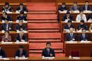 China's Communist Party Chief Xi Jinping pauses as China's National People's Congress Chairman Wu Bangguo delivers a work report at the Great Hall of the People