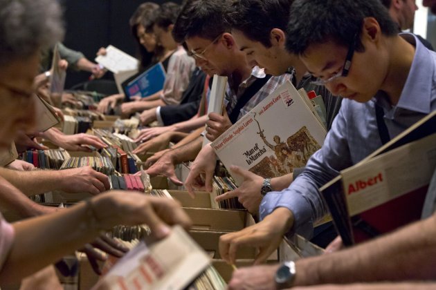 People browse through boxes of records in the New York City Public Library for the Performing Arts at Lincoln Center, Friday, Aug. 9, 2013. The library is selling 22,000 duplicate vinyl records that were preserved in mint condition to raise money for the expansion of the library. (AP Photo/Richard Drew)