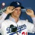New Los Angeles Dodgers pitcher Zack Greinke adjusts his cap during a baseball news conference announcing his $147 million, six-year contract, Tuesday, Dec. 11, 2012, in Los Angeles. (AP Photo/Damian Dovarganes)