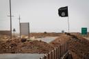 A flag of the Islamic State group is seen on the road between Kirkuk and Tikrit in Iraq, on September 11, 2014