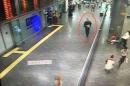 A still image from CCTV camera shows a man believed to be one of the attackers walking inside the terminal carrying a weapon as bystanders and travellers run for cover at Istanbul airport