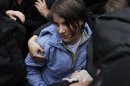 Samutsevich, a member of the female punk band "Pussy Riot", walks after she was freed from the courtroom in Moscow