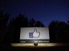 The sun rises behind the entrance sign to Facebook headquarters in Menlo Park before the company's IPO launch,