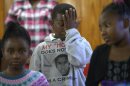 Sam Hill, 11, wipes away tears during a youth service at the St. Paul Missionary Baptist Church in Sanford, Fla., Sunday, July 14, 2013. Many in the congregation wore shirts in support of Trayvon Martin following the not guilty verdict for George Zimmerman, who had been charged in the 2012 shooting death of Martin.(AP Photo/Phelan M. Ebenhack)