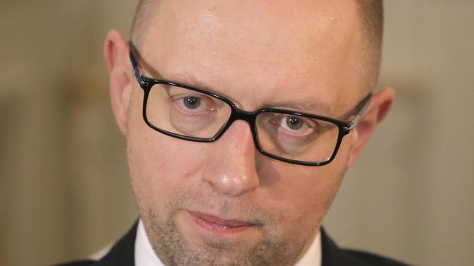Ukrainian Prime Minister Arseniy Yatsenyuk talks with reporters during an interview with the Associated Press in Kiev, Ukraine, Friday, March 27, 2015.  Yatsenyuk said in an interview with The Associated Press, Friday, that Russia was uninterested in de-escalating Ukraine’s conflict with separatist forces, despite a commitment to maintain the peace made in a February cease-fire agreement.   (AP Photo/Efrem Lukatsky)
