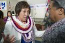 U.S. Rep. Colleen Hanabusa, Democrat, from Hawaii's 1st district, talks to former Hawaii Governor Ben Cayetano, right, at her campaign headquarters Saturday, Aug. 9, 2014, in Honolulu. Hanabusa is locked in a tight race with incumbent Sen. Brian Schatz in the state's Primary Election. (AP Photo/Eugene Tanner)
