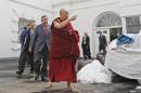 FILE - The Dalai Lama walks out of the White House in Washington, in this Thursday, Feb. 18, 2010 file photo, after meeting with President Barack Obama. Obama is to sit at the head table Thursday Feb. 5, 2015 with other speakers for the annual National Prayer Breakfast, which brings together U.S. and international leaders from different parties and faiths for one spiritual hour. Event organizers say the spiritual leader of Tibetan Buddhism will be in the audience of about 3,600, seated close to the dais and actor Richard Gere, a friend and follower. (AP Photo/Charles Dharapak, File)
