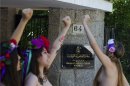Activists of FEMEN shout for the release of fellow activists, who are imprisoned in Tunisia during a protest outside the Tunisian embassy in Madrid, Spain Wednesday June 12, 2013. (AP Photo/Paul White)