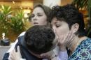 Nicole Yorksmith, right, kisses her three-year-old biological son while he is held by her spouse, Pam Yorksmith, during a news conference, Friday, April 4, 2014, in Cincinnati. Civil rights attorneys are arguing in Federal Court on Friday that a federal judge should prohibit Ohio officials from enforcing the state's ban on gay marriage. (AP Photo/Al Behrman)